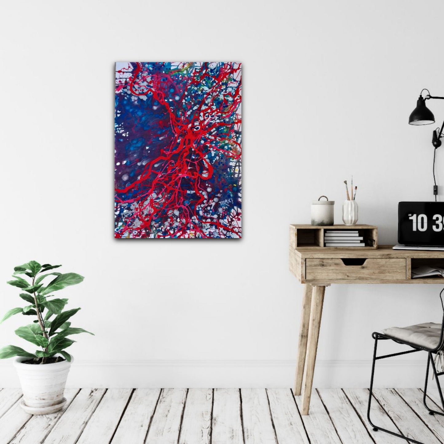 Blood Connection original red, blue, and silver abstract painting by Diana Dimova TRAXI ART. Winner of First Prize in San Francisco 2024. Abstract canvas wall art featuring a vibrant red branching pattern over a deep blue background with white and pink splatters, displayed on a white wall in a modern home office setting next to a wooden desk and a potted plant.