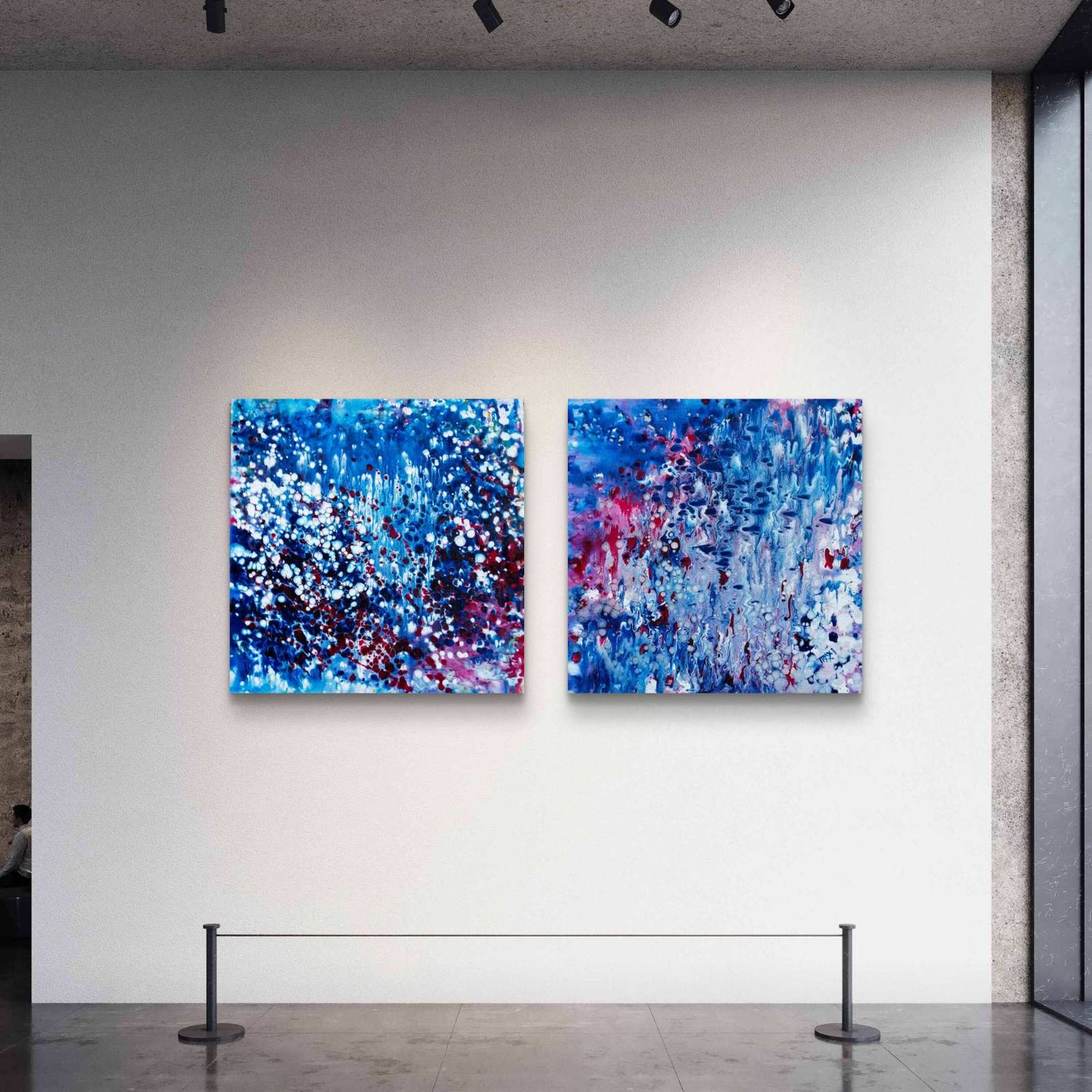 Two modern blue abstract ocean paintings displayed in a luxury gallery interior, representing the award-winning Abstract Oceans Blue Silence collection by TRAXI ART