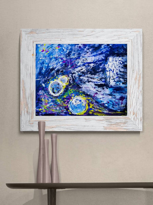 0101 New Time is Coming limited edition abstract print in dark blue by contemporary artist Diana Dimova TRAXI. A framed abstract painting featuring vibrant blue, purple, and yellow brushstrokes, displayed on a beige wall above a dark shelf with two tall metallic vases.