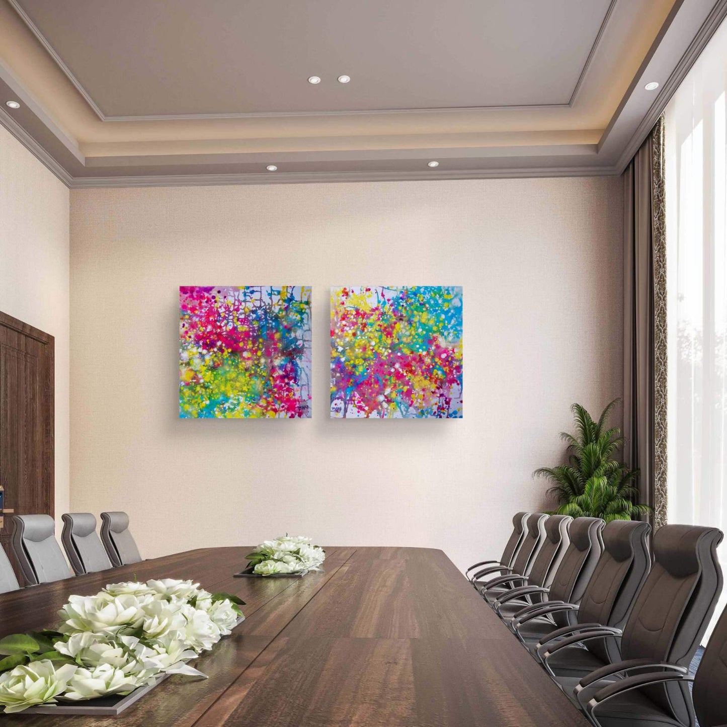 Paintings of Happiness Dyptich by Diana Dimova TRAXI,  Colorful Abstract Art Set. Two square abstract wall art prints with vibrant multicolor paint splatters hang on a beige wall in a modern conference room with a wooden table and chairs.