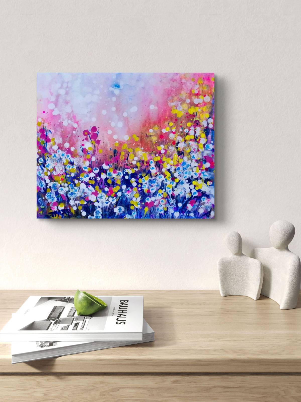 Original Painting, Life is Wonderful, Abstract Landscape, Dandelions Art, Pink and Blue Abstract, Small Art Gift, Diana Dimova TRAXI, Romantic Painting, Contemporary Fine Art, 30x25 cm A colorful abstract floral painting on canvas is displayed on a light beige wall above a wooden console table. The painting features a vibrant mix of pink, blue, purple, yellow, and white brushstrokes representing wildflowers.