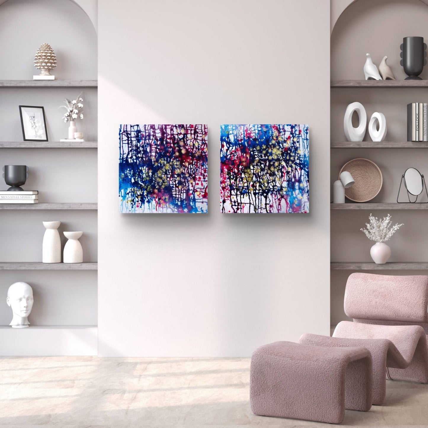 Award-winning original abstract diptych Greed and Fear by Diana Dimova TRAXI, fluid acrylic pouring in white, blue, rose and gold tones Two square abstract wall art canvases with vibrant blue, purple, pink, and white paint splatters hang side-by-side on a light gray wall in a modern, minimalist living room setting.