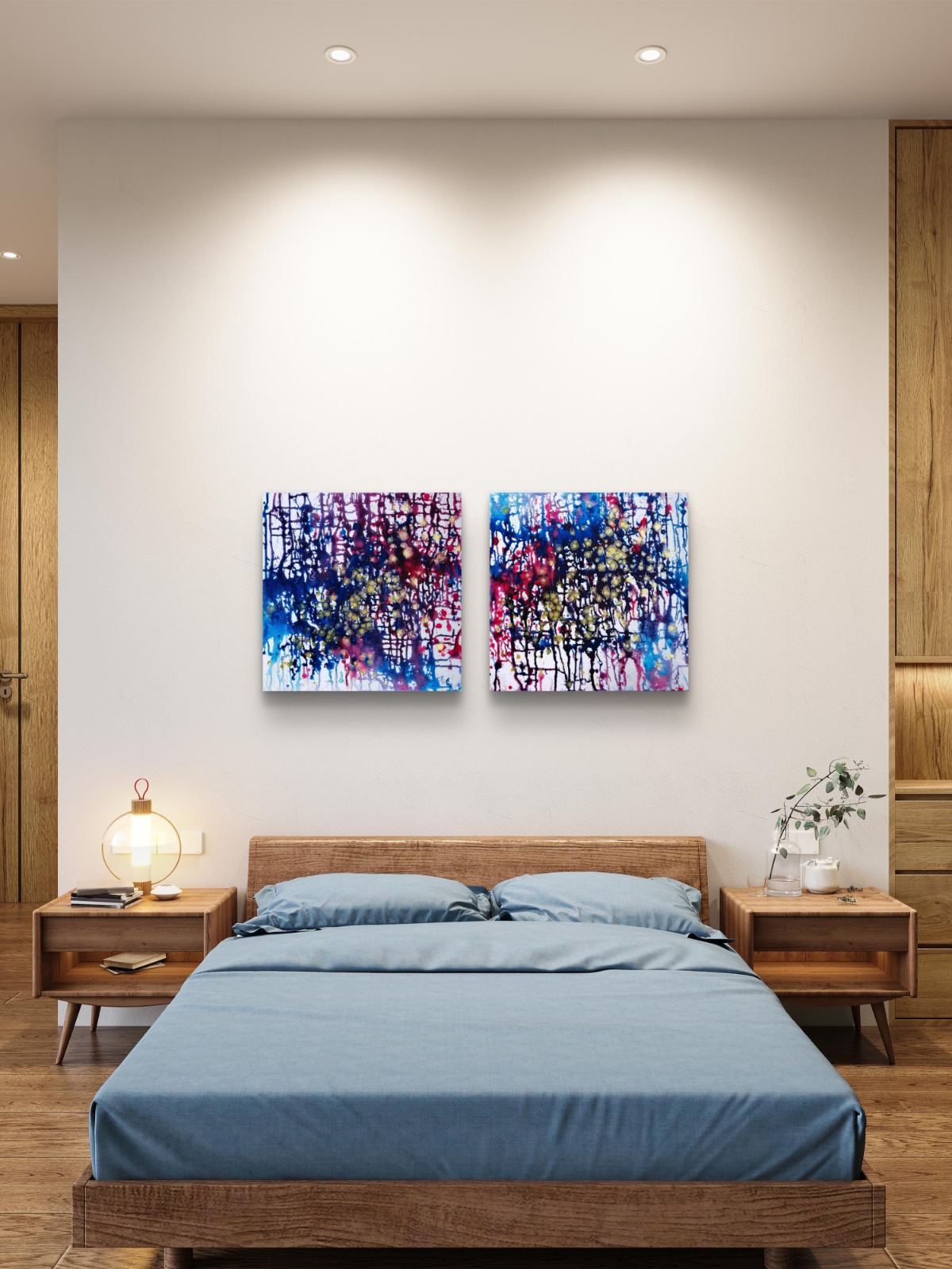 Award-winning original abstract diptych Greed and Fear by Diana Dimova TRAXI, fluid acrylic pouring in white, blue, rose and gold tones A modern bedroom featuring two colorful abstract canvas prints hanging on a light beige wall above a wooden bed with blue bedding.