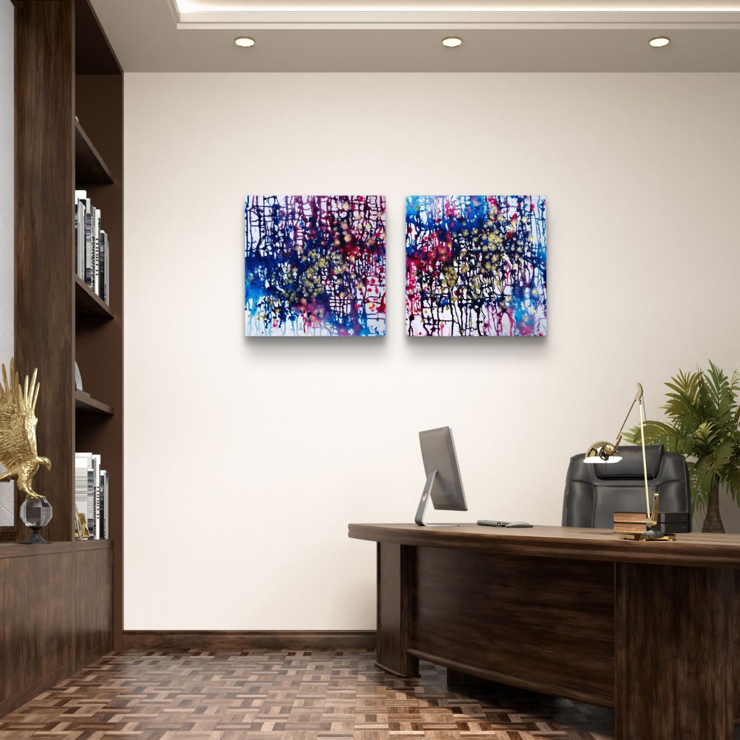 Award-winning original abstract diptych Greed and Fear by Diana Dimova TRAXI, fluid acrylic pouring in white, blue, rose and gold tones Two square abstract wall art prints with blue, purple, pink, and white paint splatters hang on a beige wall in a modern office setting with a wooden desk, computer, and plant.