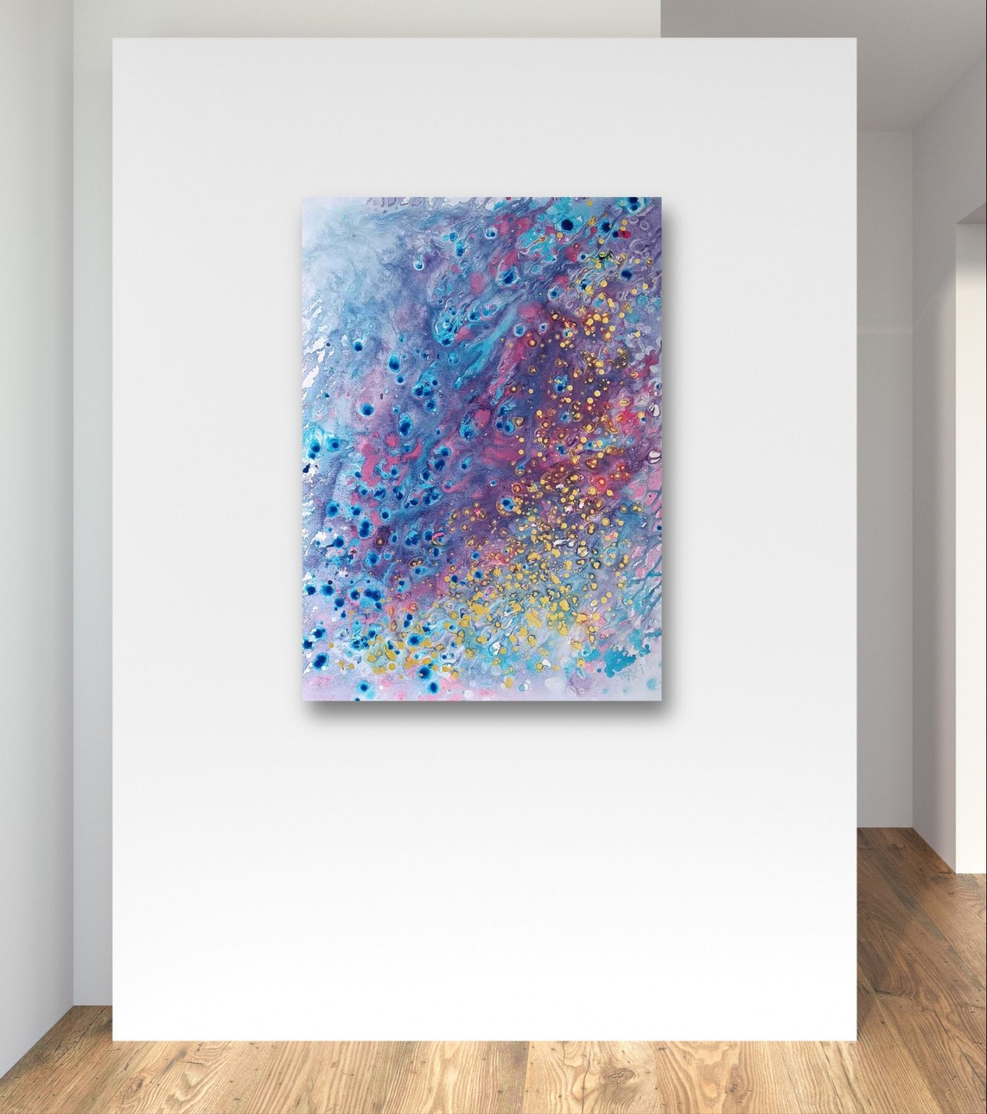 Award-winning original spiritual abstract painting Noise from Dreams by Diana Dimova TRAXI, fluid acrylic pouring in soft white, blue, rose and gold tones. An abstract canvas painting with swirling blue, purple, pink, and white textures and scattered gold glitter, displayed on a white wall above a light wood floor.