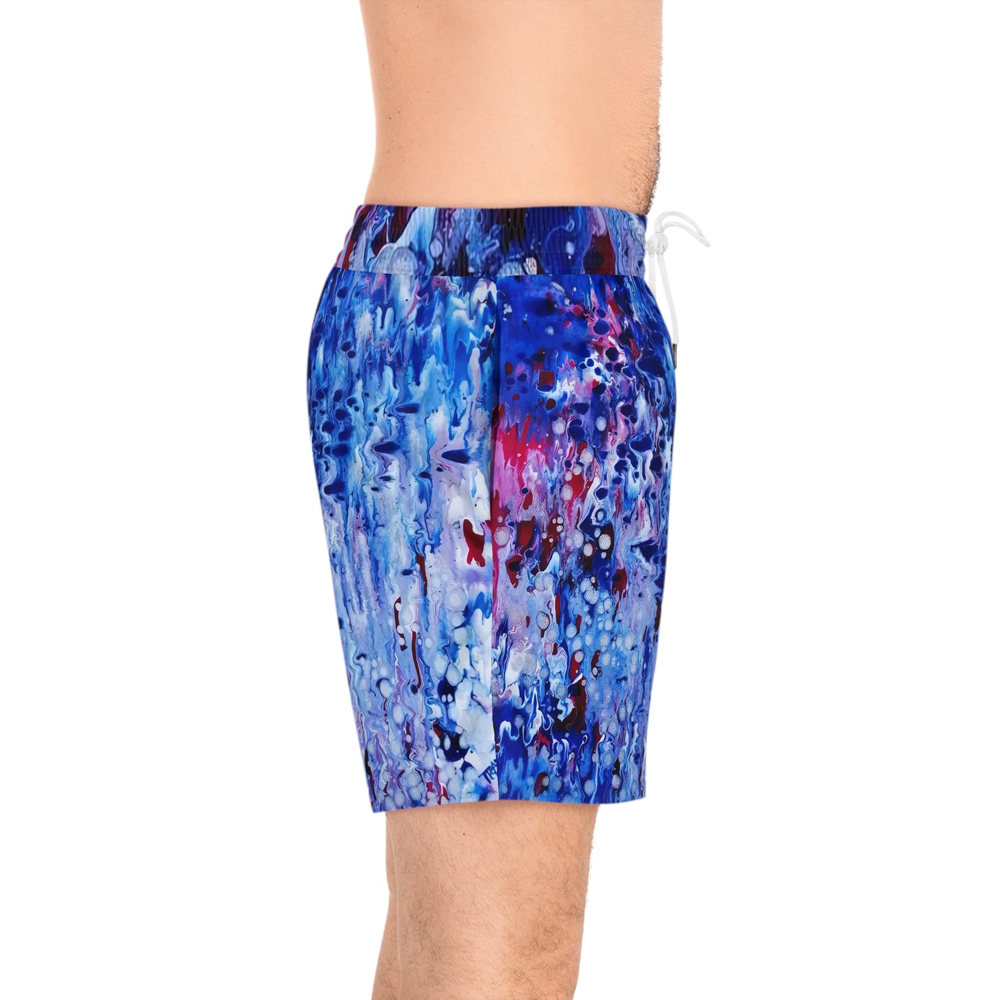 Men's blue ocean swim shorts featuring wearable art inspired by blue underwater paintings by Diana Dimova TRAXI. Men's swim trunks featuring an abstract blue, purple, and red paint splatter pattern, shown on a model against a white background.