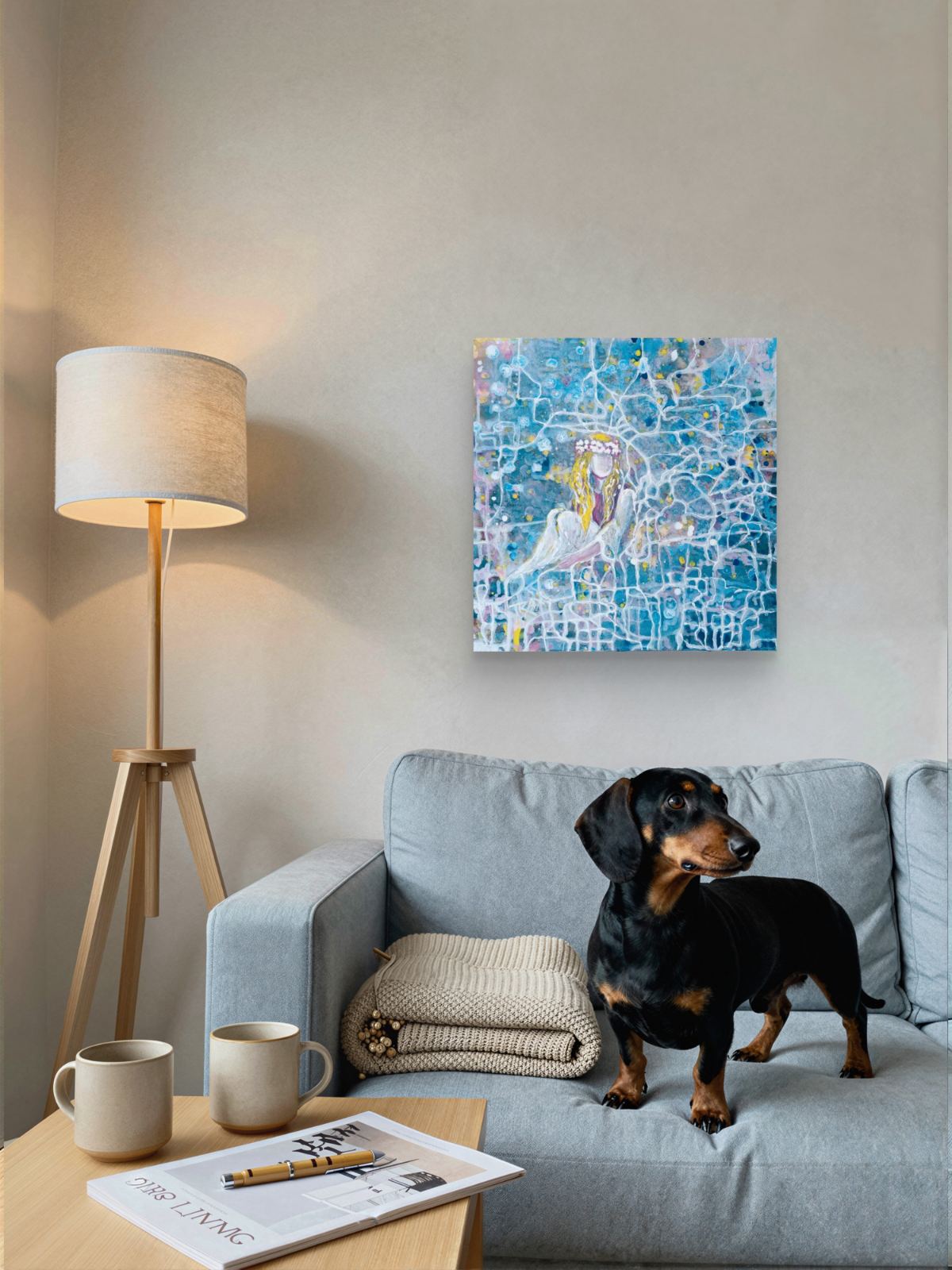 Original abstract figurative painting Connected to the Universe by Diana Dimova TRAXI, featuring a luminous figure emerging from a network of flowing lines. A square canvas art print featuring a blue mosaic-style illustration of a woman in a white dress, displayed on a beige wall above a light blue sofa with a black and tan dachshund standing nearby.