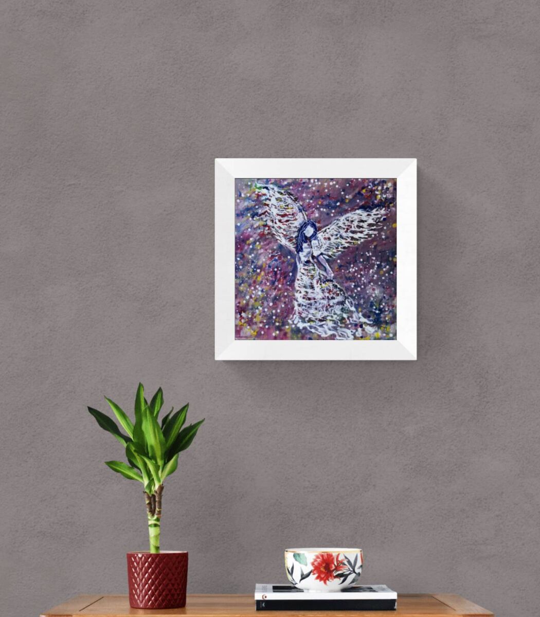 Original abstract figurative painting White Angel by Diana Dimova TRAXI, featuring spiritual symbolism in purple and white tones. A framed abstract painting of an angel with outstretched wings, displayed on a textured gray wall above a wooden table with a potted plant and a decorative bowl.