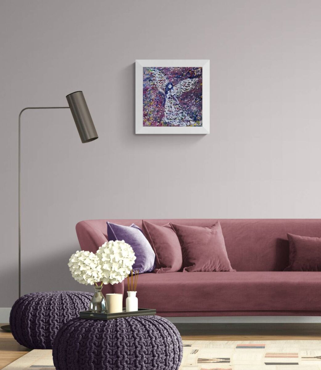 Original abstract figurative painting White Angel by Diana Dimova TRAXI, featuring spiritual symbolism in purple and white tones. A framed abstract painting featuring purple, blue, and white brushstrokes, displayed on a light gray wall above a dusty rose sofa in a modern living room setting.