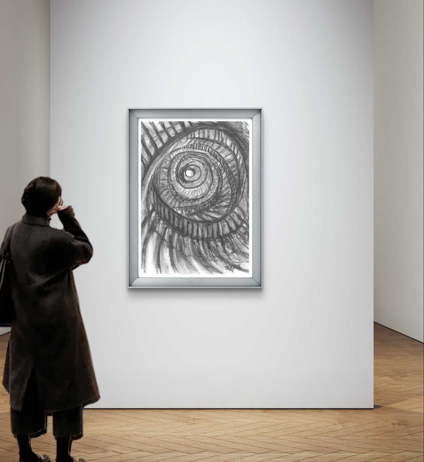 Original monochrome charcoal abstract drawing Eternal Spirals by Diana Dimova TRAXI, featuring rhythmic spiral movements in black and white tones. A framed black and white spiral artwork hangs on a white gallery wall, with a person in a dark coat standing nearby and taking a photo. The room has light wood flooring.