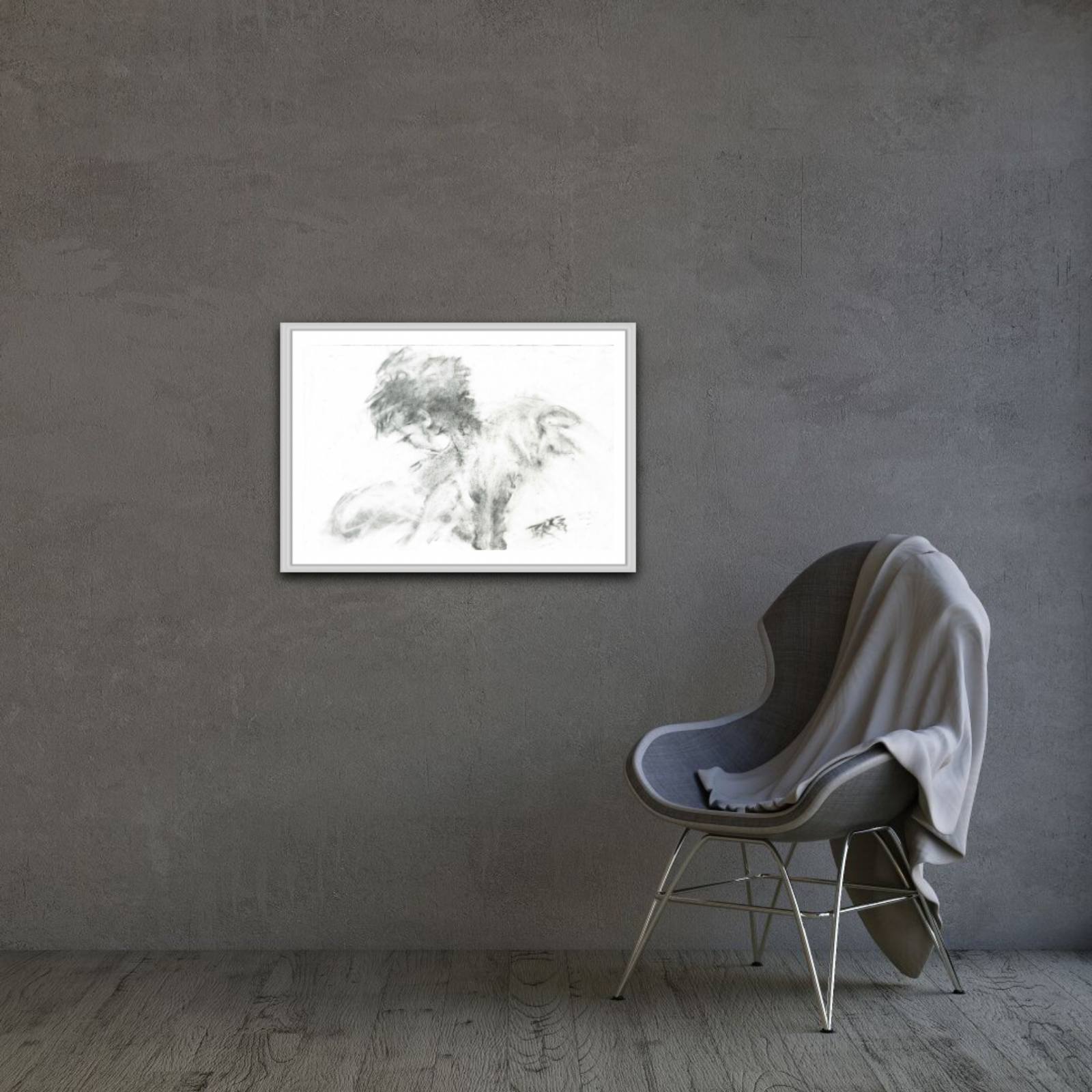 Original monochrome abstract charcoal drawing Rebirth by Diana Dimova TRAXI, featuring black and white contrasts celebrating nature and renewal. A framed black and white sketch print of two dogs hanging on a textured gray wall in a modern room setting with a gray chair and draped blanket.