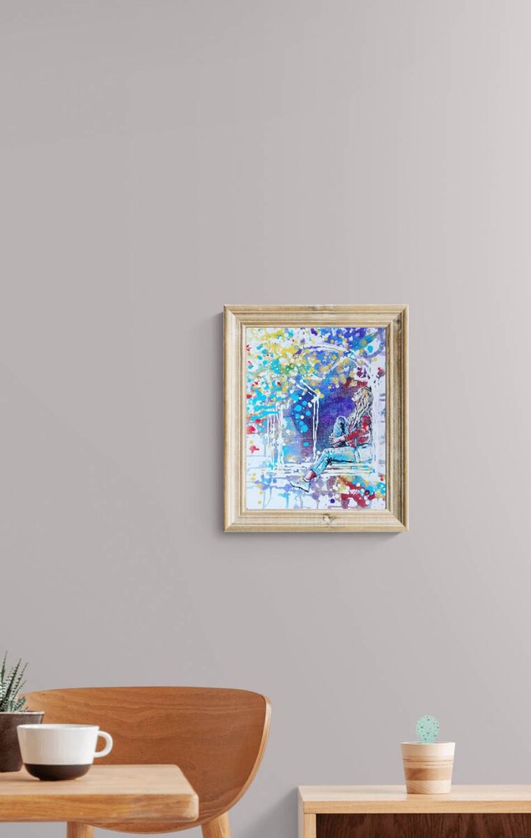 Original framed painting Talking with the Stars by Diana Dimova TRAXI, featuring a spiritual window composition with a girl reaching toward a starry night sky. A framed abstract painting with vibrant blue, yellow, and red brushstrokes, displayed on a light gray wall above a wooden chair and side table.
