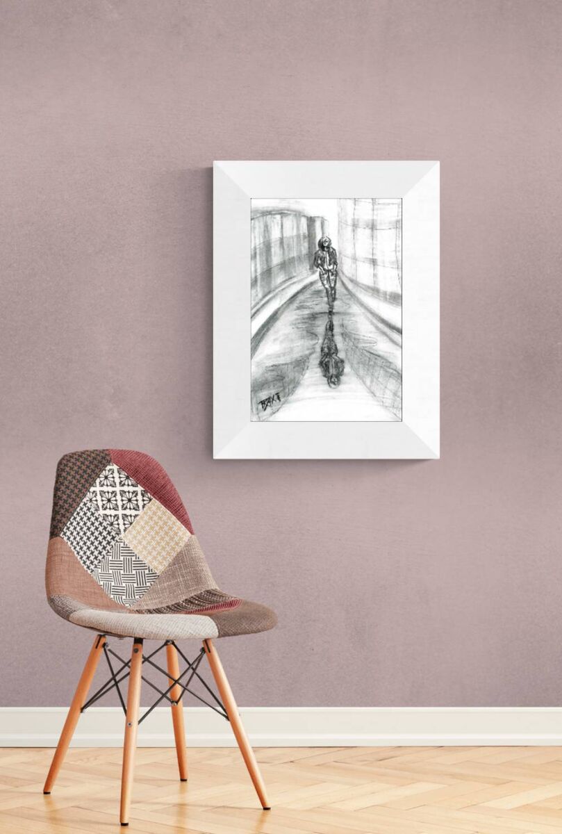 Original neo-noir urban charcoal drawing Alone with Myself by Diana Dimova TRAXI, featuring a woman and reflection exploring solitude in black and white. A framed black and white art print depicting a cyclist on a bridge, hung on a textured mauve wall above a modern patchwork chair with wooden legs.