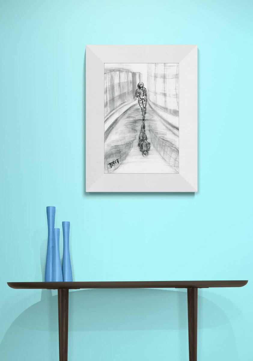 Original neo-noir urban charcoal drawing Alone with Myself by Diana Dimova TRAXI, featuring a woman and reflection exploring solitude in black and white. A framed black and white pencil sketch of a cyclist on a track, displayed on a light blue wall above a dark wooden console table with blue vases.