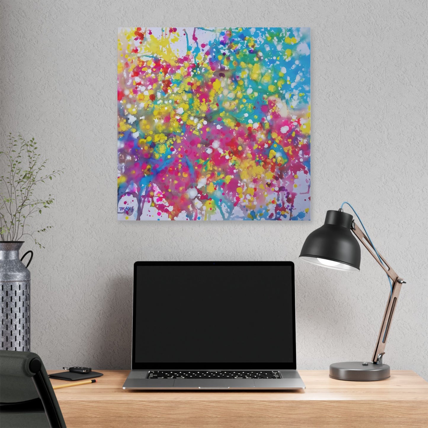 Painting of happiness 2 vibrant abstract canvas print by award-winning contemporary artist Diana Dimova - TRAXI, featuring radiant pink, yellow, and blue colors. A colorful abstract tree artwork hanging on a light gray wall above a wooden desk with an open laptop, a black desk lamp, and a decorative vase.