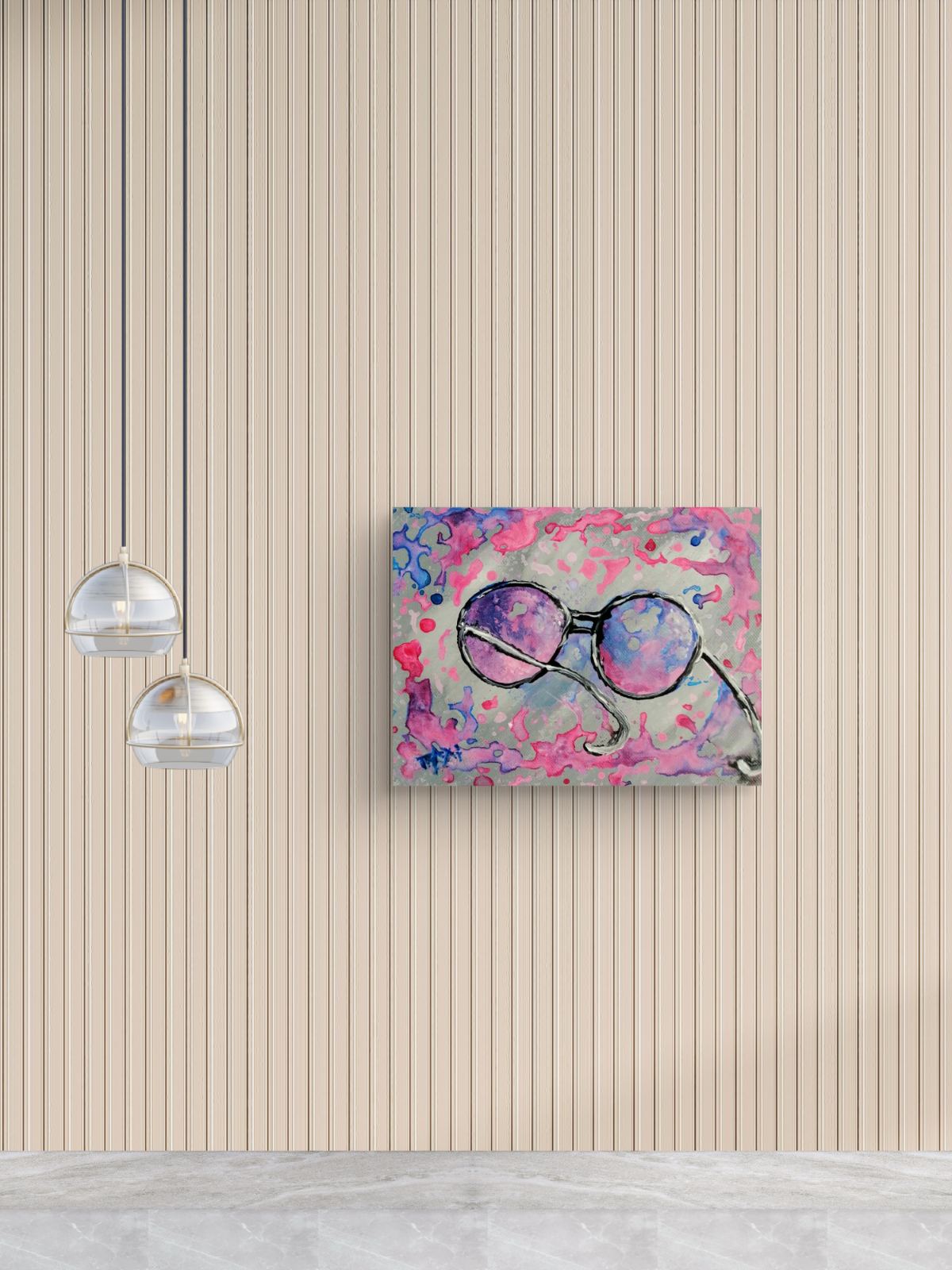 Pink glasses original abstract painting by contemporary artist TRAXI, featuring vibrant fluid acrylics and a joyful, perfect gift idea . A square abstract art print featuring a pair of round sunglasses in purple, pink, and blue tones, mounted on a beige wood-paneled wall next to two hanging glass pendant lights.