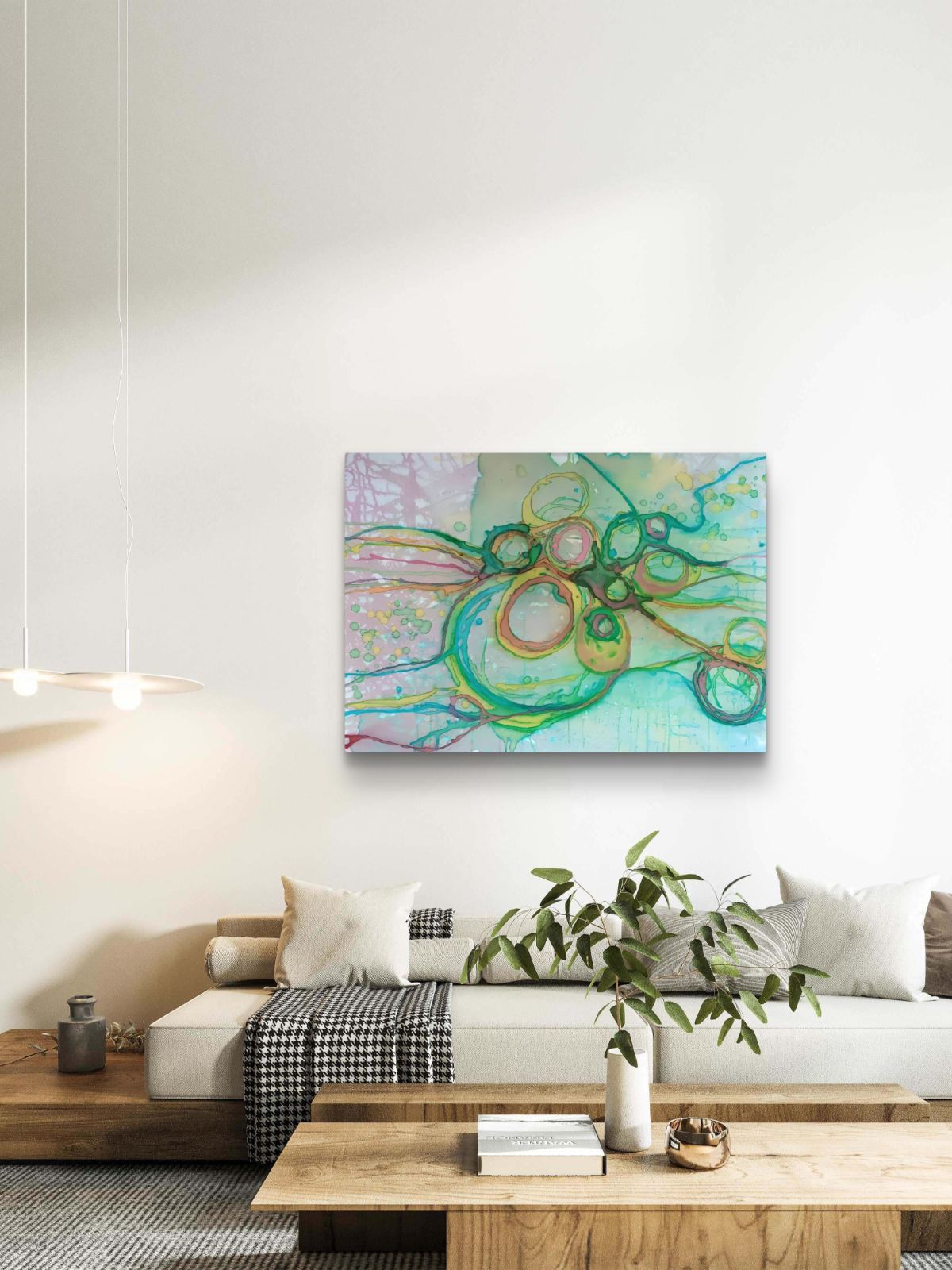 Original abstract painting titled 'The Balance' by TRAXI featuring serene textures and organic rhythms. The artwork represents the culmination of the series States of Becoming, exploring harmony, nature, and spiritual equilibrium. An abstract canvas art print featuring green, teal, and pink swirls, displayed on a white wall above a modern white sofa in a styled living room.