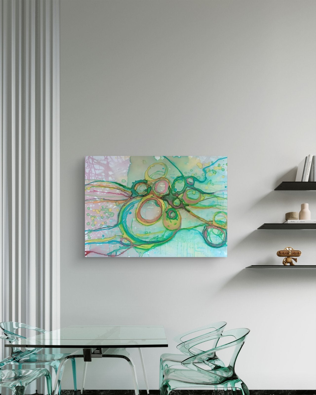 Original abstract painting titled 'The Balance' by TRAXI featuring serene textures and organic rhythms. The artwork represents the culmination of the series States of Becoming, exploring harmony, nature, and spiritual equilibrium. An abstract canvas wall art print featuring green, teal, and gold circular patterns on a pastel background, displayed on a light gray wall in a modern dining room setting.