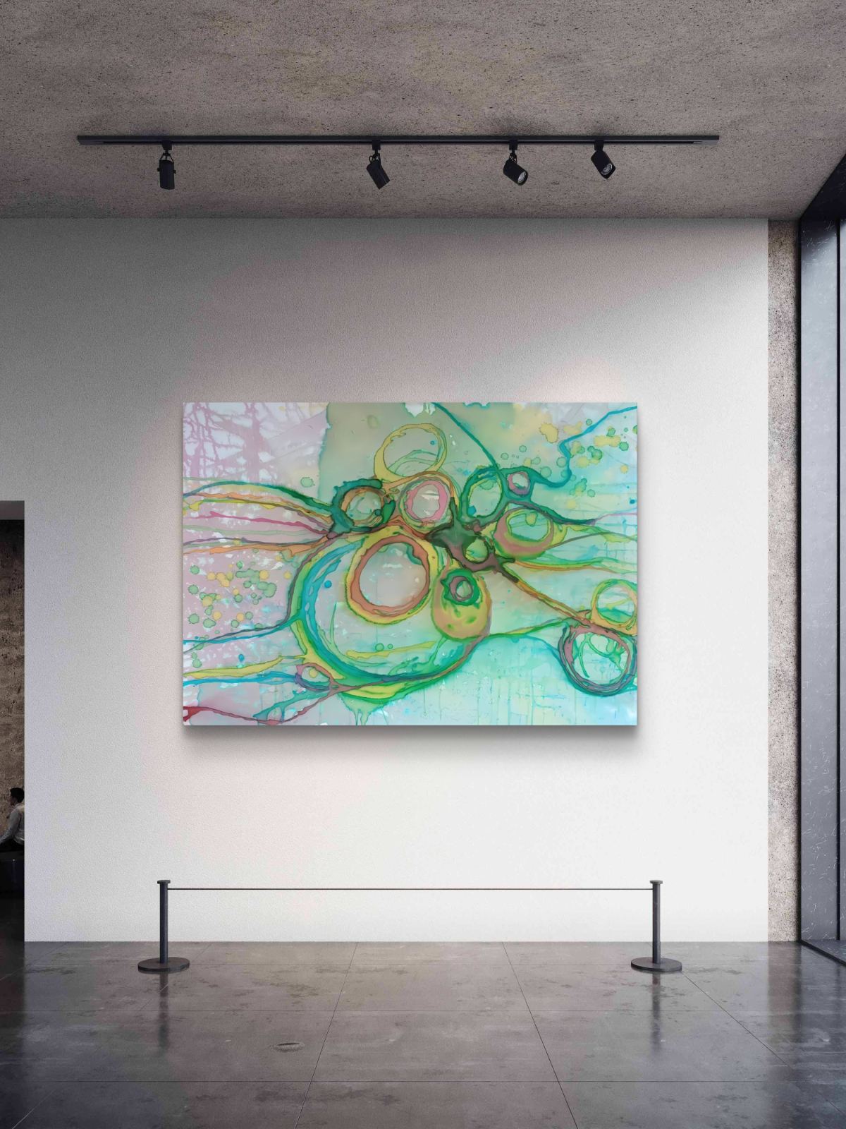 Original abstract painting titled 'The Balance' by TRAXI featuring serene textures and organic rhythms. The artwork represents the culmination of the series States of Becoming, exploring harmony, nature, and spiritual equilibrium. An abstract canvas painting with flowing green, yellow, and light blue lines and circular forms, displayed on a white gallery wall in an art museum with a concrete ceiling and track lighting.