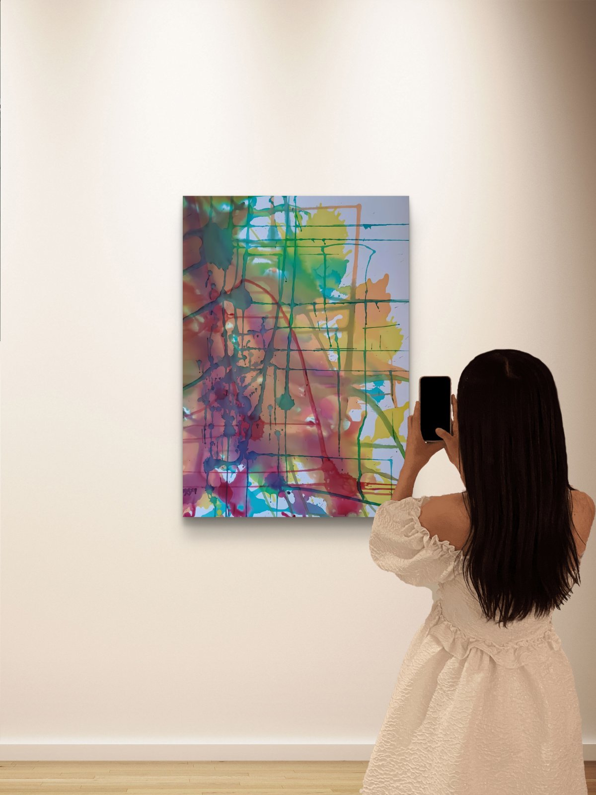 Original abstract painting titled 'The Fracture' by TRAXI, featuring expressive textures and dynamic movement. The artwork explores themes of change and emotional transformation through contemporary abstract expressionism. A woman in a cream off-the-shoulder dress takes a photo of a colorful abstract canvas painting hanging on a white gallery wall.