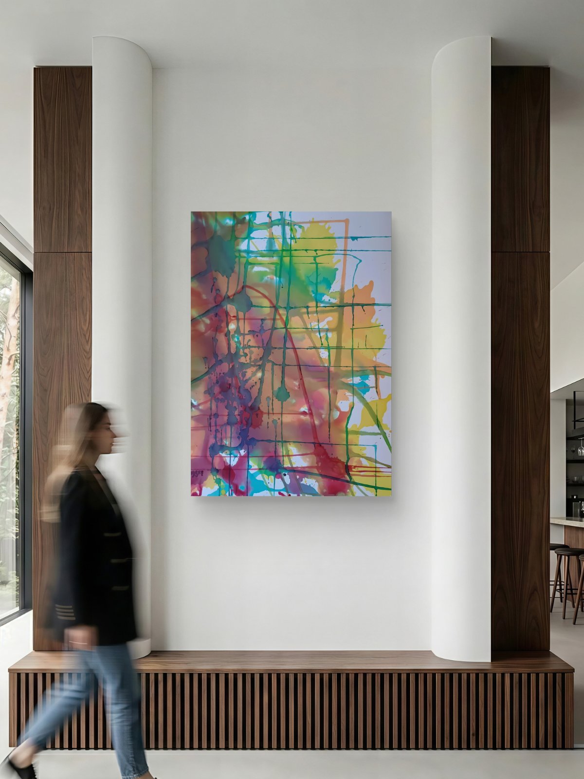 Original abstract painting titled 'The Fracture' by TRAXI, featuring expressive textures and dynamic movement. The artwork explores themes of change and emotional transformation through contemporary abstract expressionism. A colorful abstract canvas print with vibrant splashes of yellow, green, blue, pink, and purple, displayed on a white wall in a modern interior setting with a blurred person walking past.