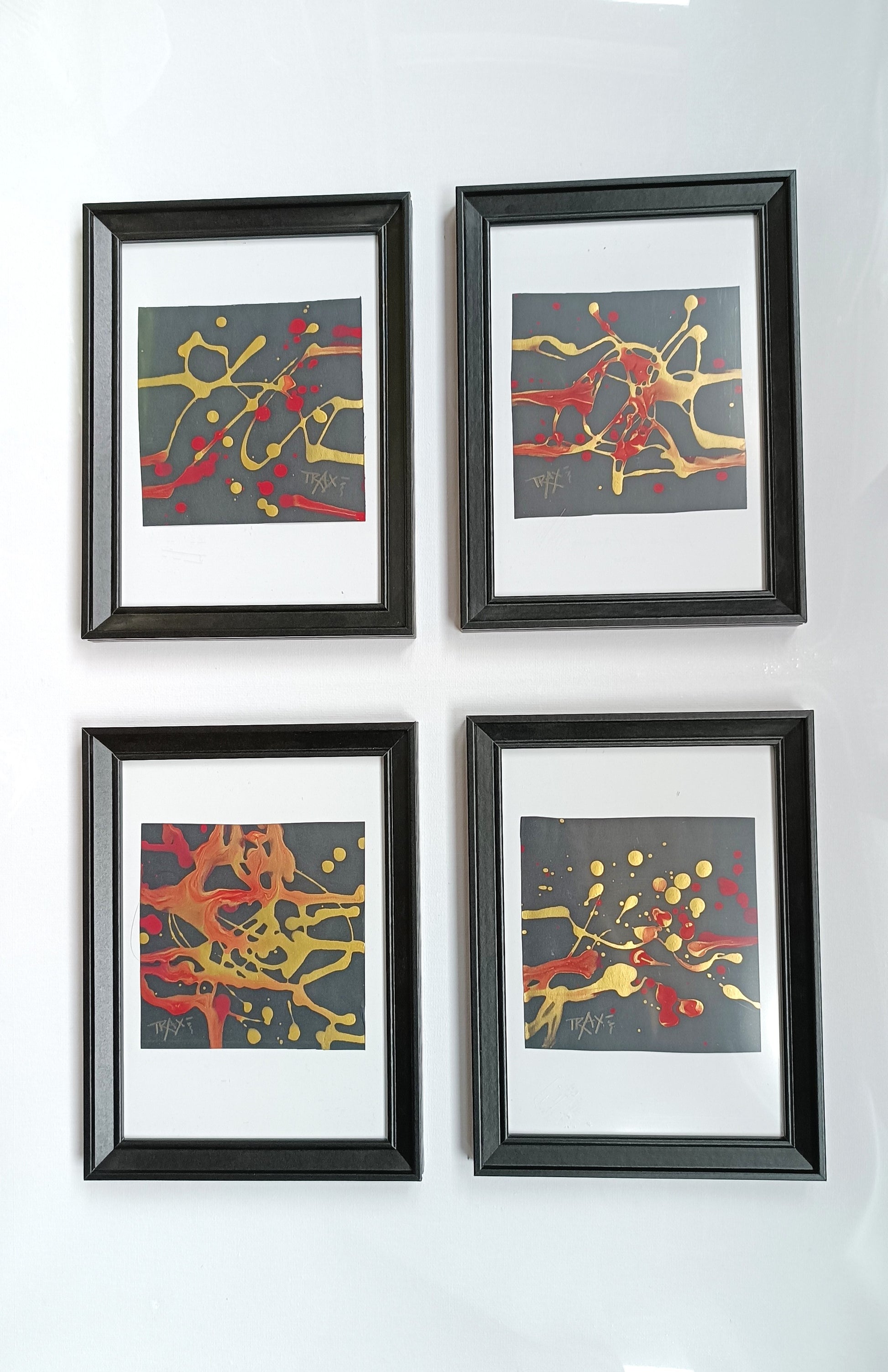 The complete SIGNS art collection by Diana Dimova - TRAXI, featuring all four abstract miniature paintings in luxury black frames displayed together.