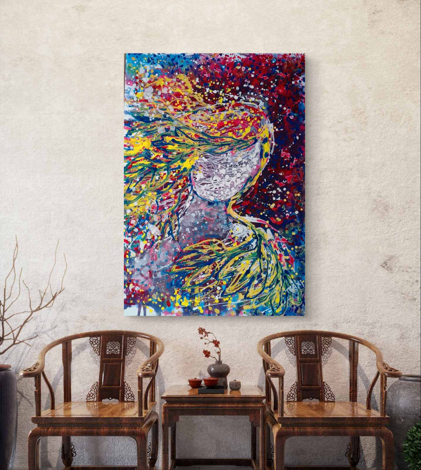 A colorful abstract canvas painting of a woman's profile with flowing hair, displayed on a textured beige wall above two wooden armchairs and a small side table. Autumn’s Smile original abstract portrait fluid acrylic painting with warm burgundy, gold, and orange tones representing feminine autumn energy by Diana Dimova TRAXI ART.