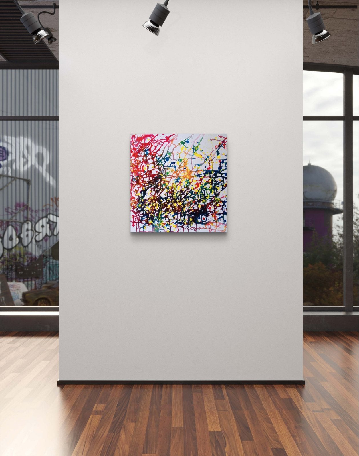 Flecks of Sunlight original fluid acrylic abstract painting by Diana Dimova TRAXI ART. Distinction Award winner 2025, San Francisco. A square abstract canvas print with vibrant multicolor paint splatters and drips, displayed on a white gallery wall in a modern room with wood floors and track lighting.