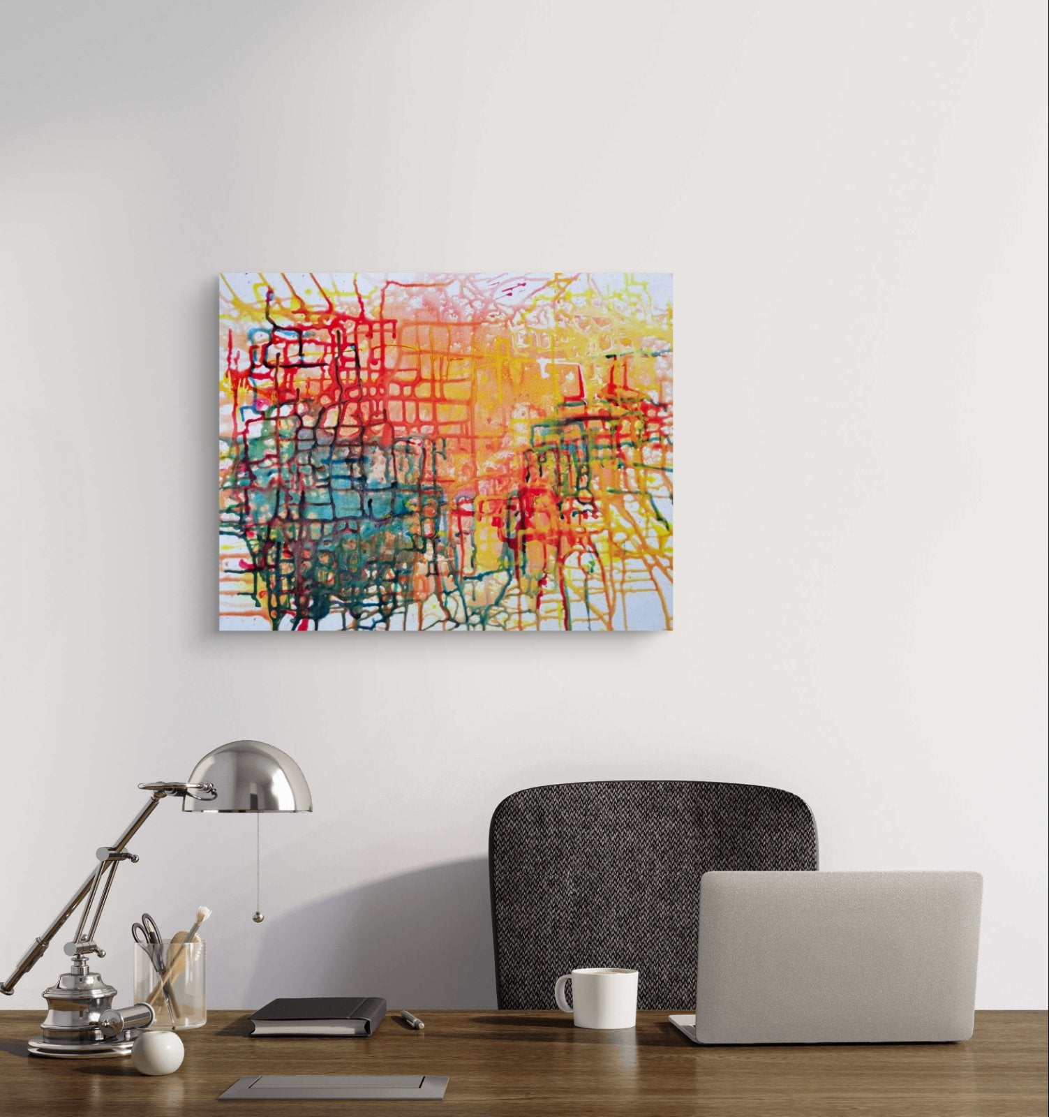Illusions original checkered abstract painting in red, yellow, green, and orange by Diana Dimova TRAXI ART. Honorable Mention Award winner 2024. A square abstract canvas print with colorful scribbled brushstrokes in red, yellow, blue, green, and orange, displayed on a white wall above a wooden desk with a laptop, lamp, and mug.
