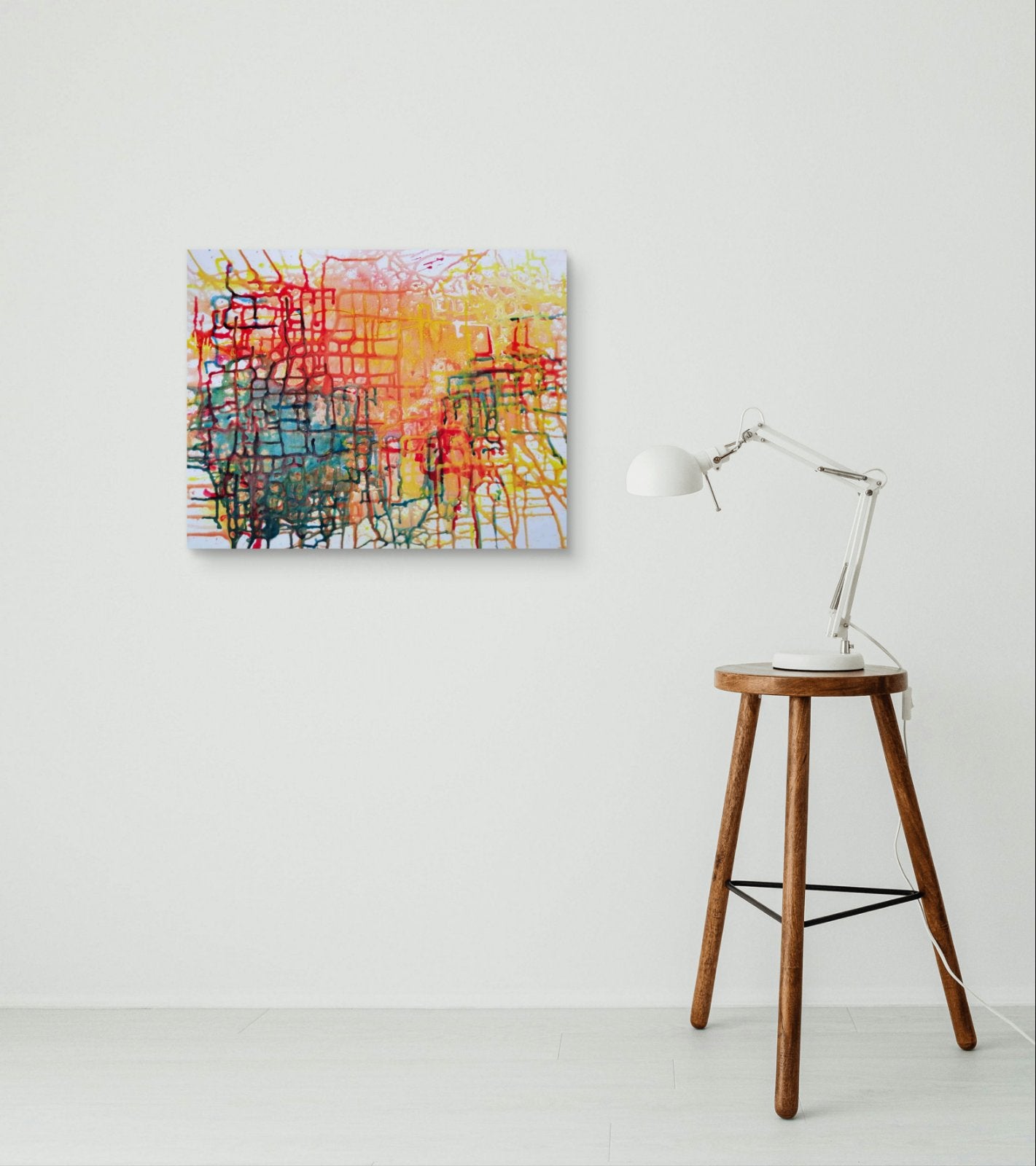 Illusions original checkered abstract painting in red, yellow, green, and orange by Diana Dimova TRAXI ART. Honorable Mention Award winner 2024. An abstract canvas painting with colorful scribbled lines in red, yellow, blue, green, and orange, displayed on a white wall next to a wooden stool with a white desk lamp.