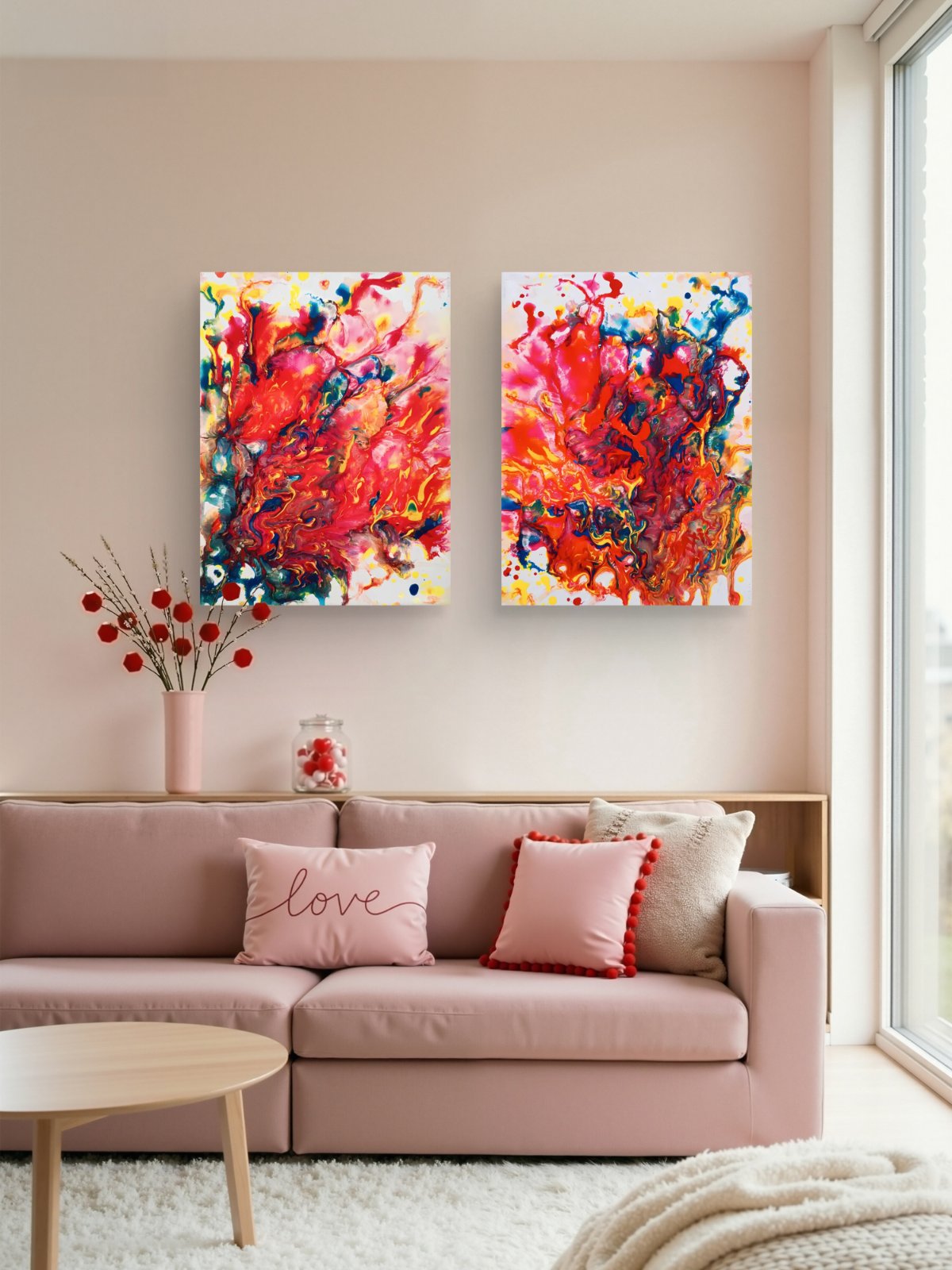 Magic Set large scale limited edition diptych print featuring bold red fluid abstract shapes by Diana Dimova TRAXI ART. A modern living room setting featuring two vertical abstract canvas prints with vibrant red, orange, pink, and blue brushstrokes, hung on a light beige wall above a dusty pink sofa with decorative pillows.