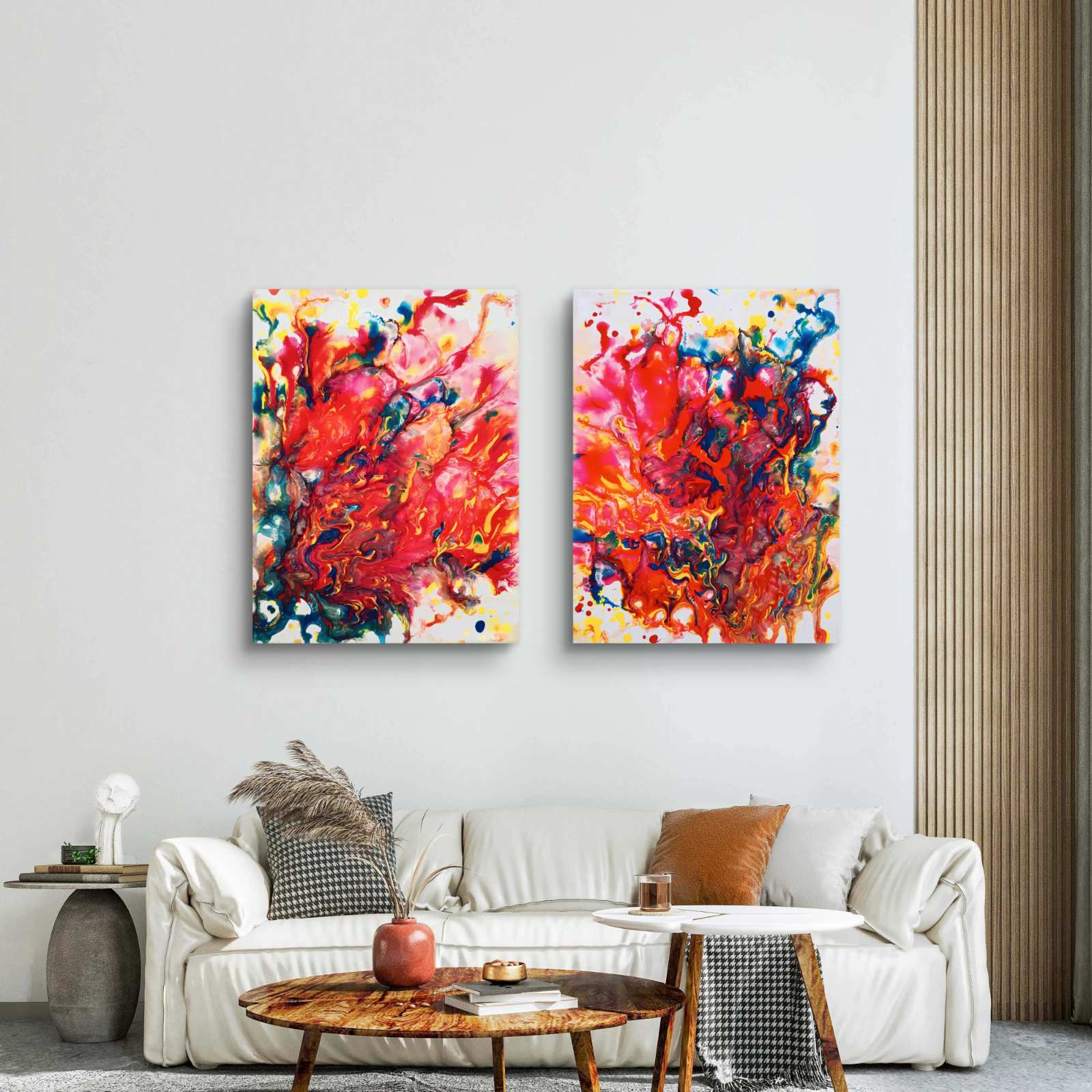 Magic Set large scale limited edition diptych print featuring bold red fluid abstract shapes by Diana Dimova TRAXI ART. Two vertical abstract canvas wall art prints with vibrant red, orange, yellow, blue, and white paint splashes, displayed side-by-side above a modern white sofa in a bright, contemporary living room.