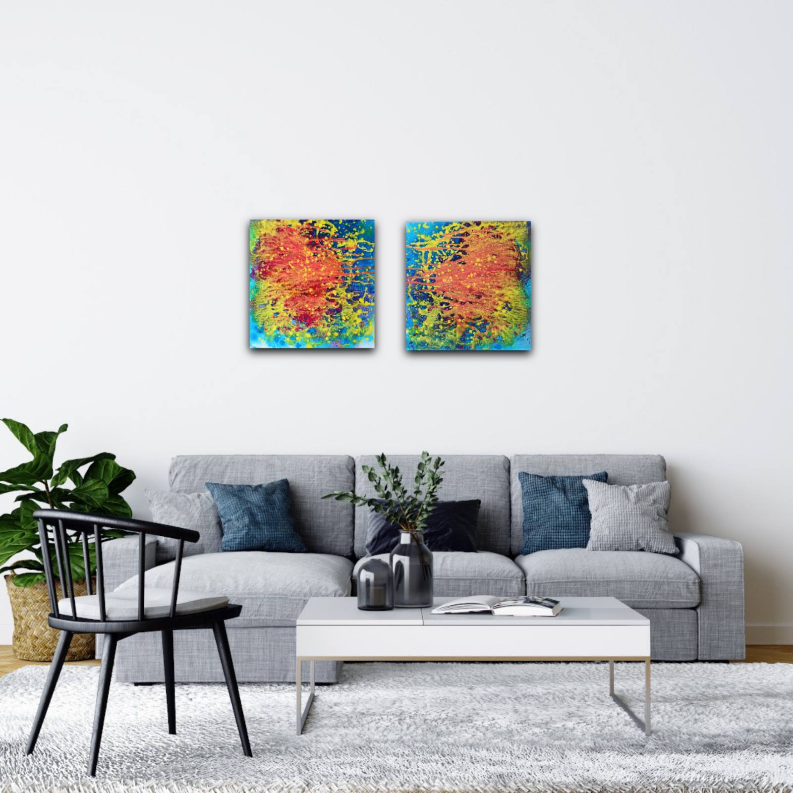 Portals of the Sun original cosmic abstract diptych in orange and yellow by Diana Dimova TRAXI ART. Bronze Award winner 2024. A modern living room setting featuring a pair of square abstract canvas prints with vibrant red, orange, yellow, and blue brushstrokes, hung side-by-side on a white wall above a gray sofa.