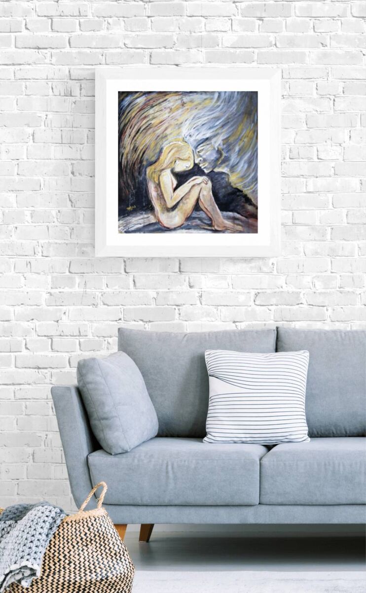 Promised by the Wind original abstract square painting with black, white, gold, and silver fluid acrylic layers by Diana Dimova TRAXI ART. A framed art print depicting an abstract painting of a seated figure, displayed on a white brick wall above a light blue sofa with a striped pillow.