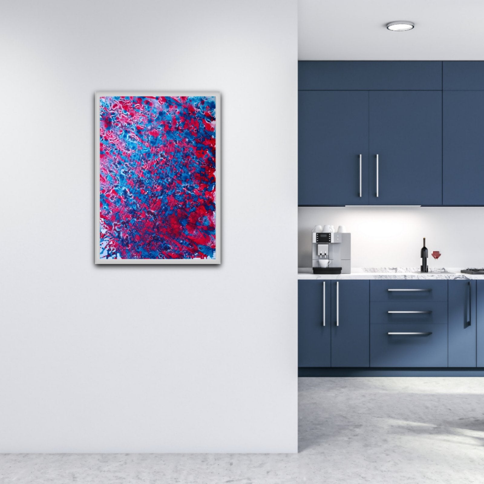 Red & Blue Balance original fluid acrylic abstract painting by Diana Dimova TRAXI ART. A framed abstract wall art print featuring vibrant blue and red brushstrokes, displayed on a white wall in a modern kitchen setting with dark blue cabinets.