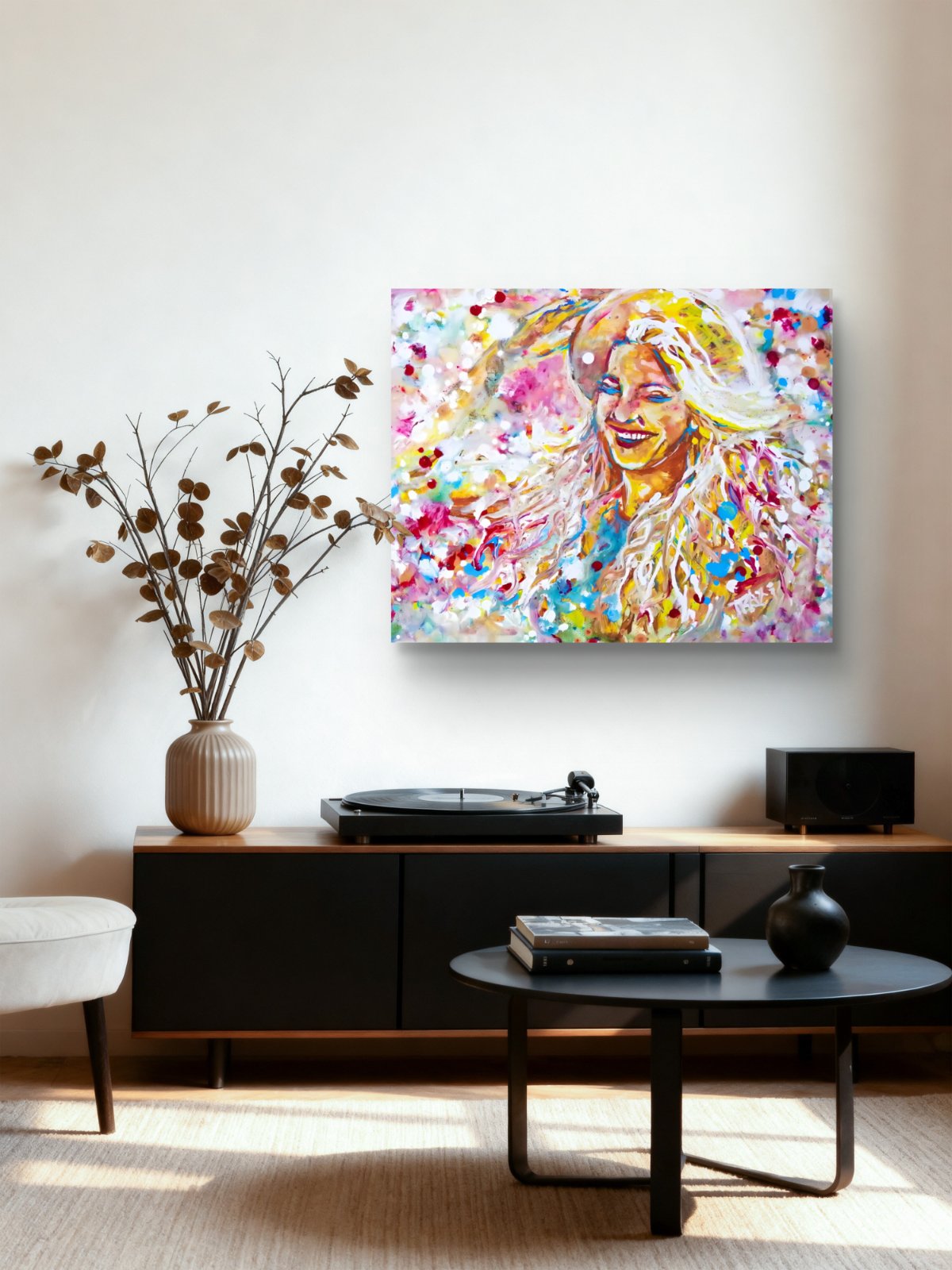 A colorful abstract portrait canvas print of a smiling woman, displayed on a white wall in a modern living room setting above a black media console. Sun in the Hair limited edition premium horizontal canvas print depicting a smiling woman in a straw hat with pink and yellow summer light by Diana Dimova TRAXI ART.