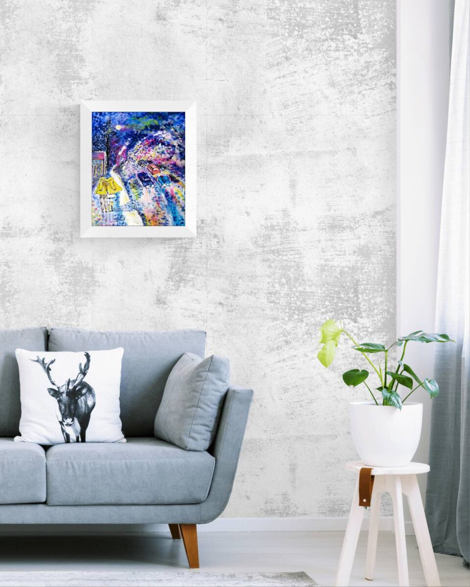 Together We Walk original romantic night city abstract fluid acrylic painting with soft blue, pink, and yellow light tones by Diana Dimova TRAXI ART. A colorful abstract framed art print hangs on a textured light gray wall above a blue-gray sofa with a black-and-white deer pillow. A potted green plant sits on a small white stool to the right.