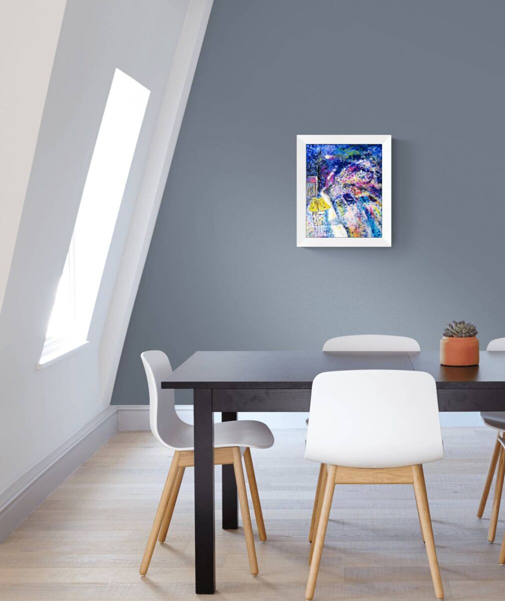 Together We Walk original romantic night city abstract fluid acrylic painting with soft blue, pink, and yellow light tones by Diana Dimova TRAXI ART. A colorful abstract art print in a white frame hangs on a dark gray wall in a modern dining room setting with a black table and white chairs.