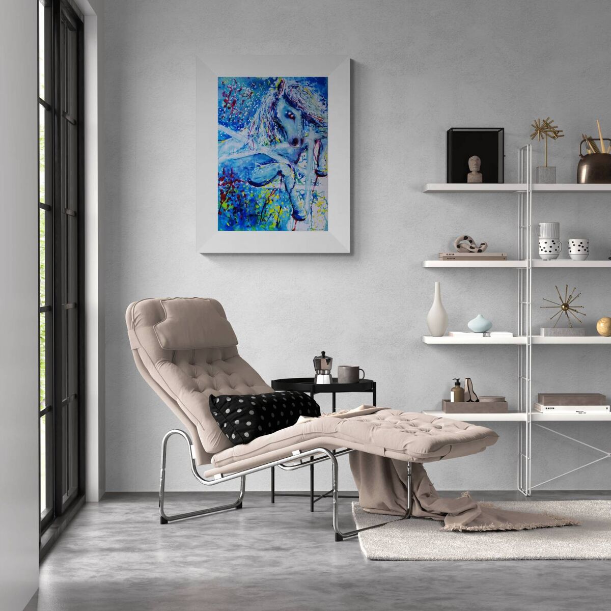A modern living room scene featuring a beige tufted chaise lounge chair with a black polka-dot pillow, next to a small black side table. On the wall above, a white-framed abstract painting with blue, purple, and white brushstrokes hangs. White Horse and Blue Freedom original symbolic fluid acrylic painting with deep blue, white, and red accents by Diana Dimova TRAXI ART.
