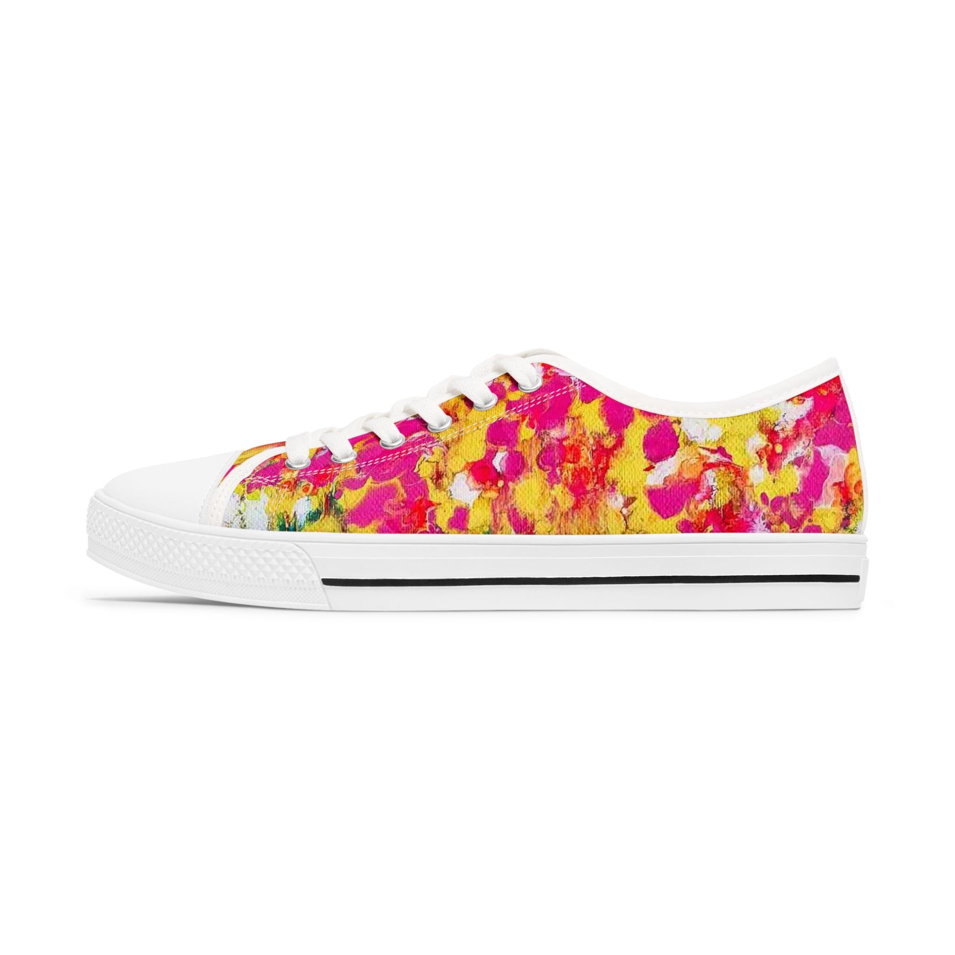 Women's low top sneakers of happiness featuring abstract wearable art inspired by the painting Summer Flowers by Diana Dimova TRAXI. A low-top canvas sneaker with a vibrant abstract floral pattern in hot pink, yellow, and red, featuring a white rubber toe cap, white laces, and a white midsole with a thin black stripe.