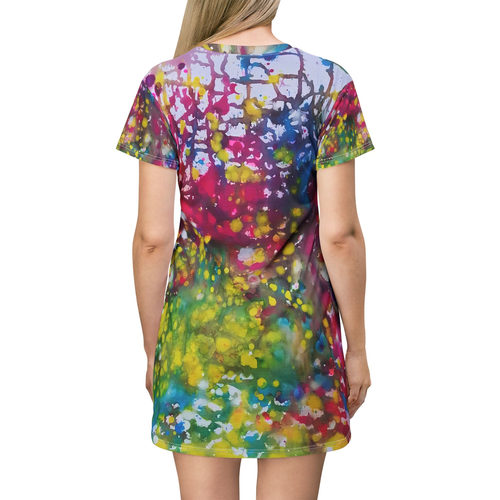 Women's summer t-shirt dress of happiness featuring abstract wearable art by Diana Dimova TRAXI. A woman shown from the back wearing a short-sleeve t-shirt dress with a vibrant multicolor abstract paint splatter pattern, set against a plain white background.